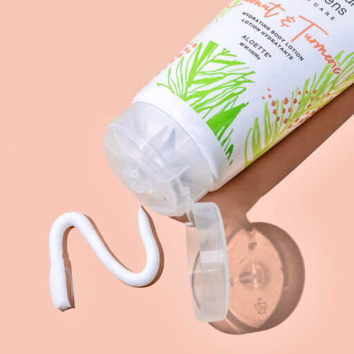 Coconut Tumeric Lotion + opened swatch + on peach + 1080x1080.jpg